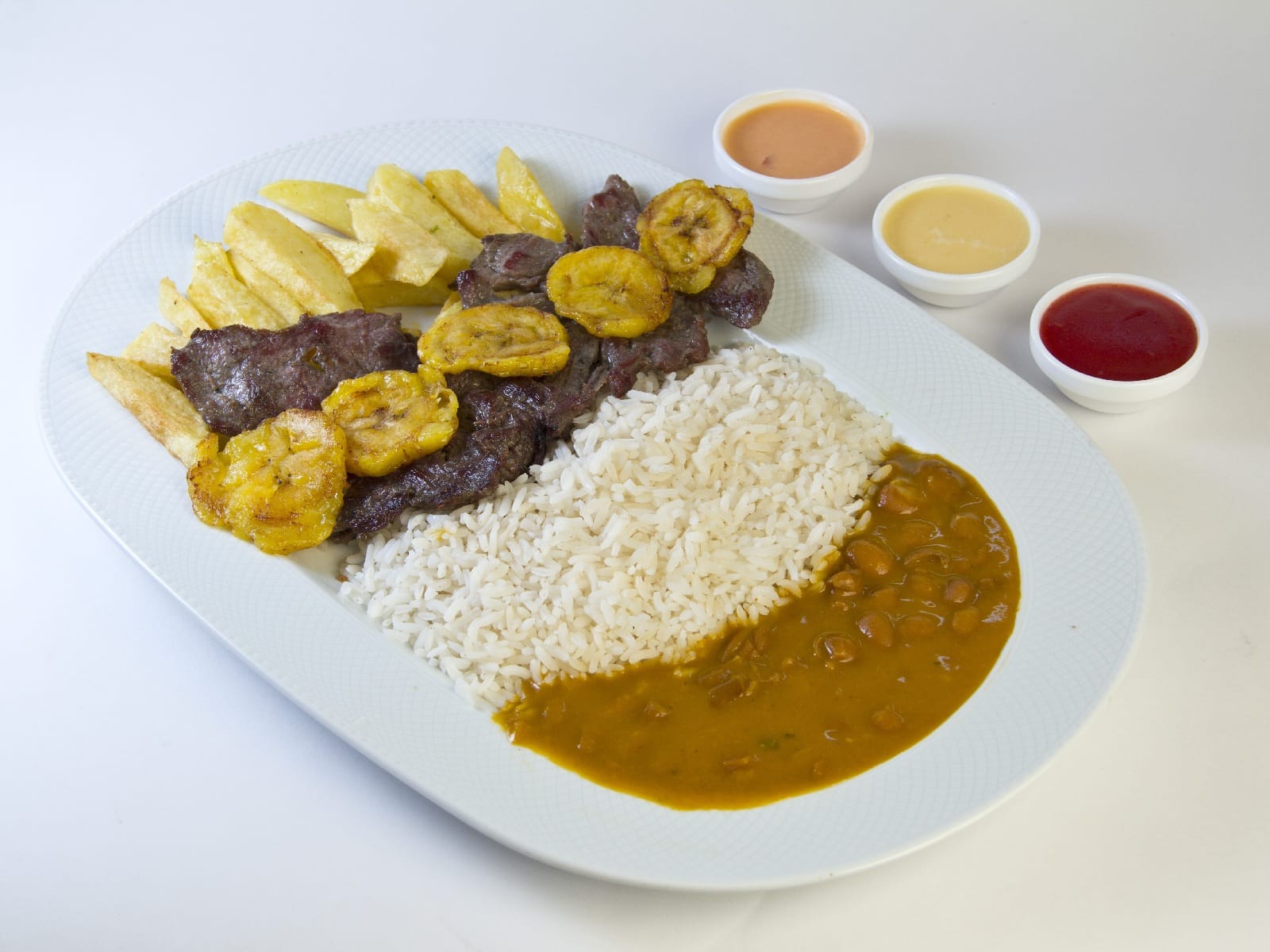 Patacones, riz et haricots dans une assiette